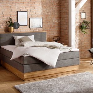CAVAN prémium boxspring franciaágy 180 × 200 cm – antracitszürke szövet, tömör tölgyfa keret, 2 ágyneműtartó, H3/H4 matrac és fedőmatrac